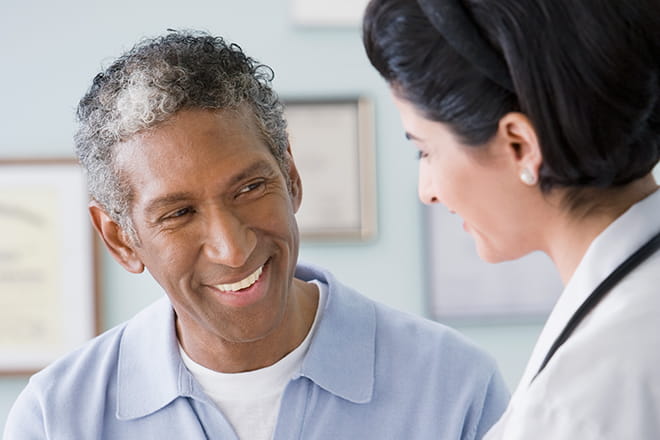 Doctor and patient discuss liver cancer diagnosis. 