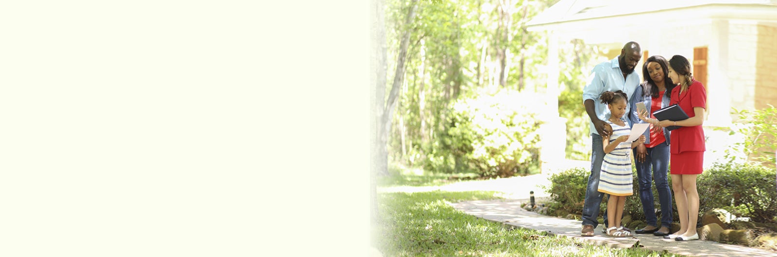 Family standing in front of home