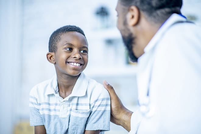 A boy talking to his pediatrician.