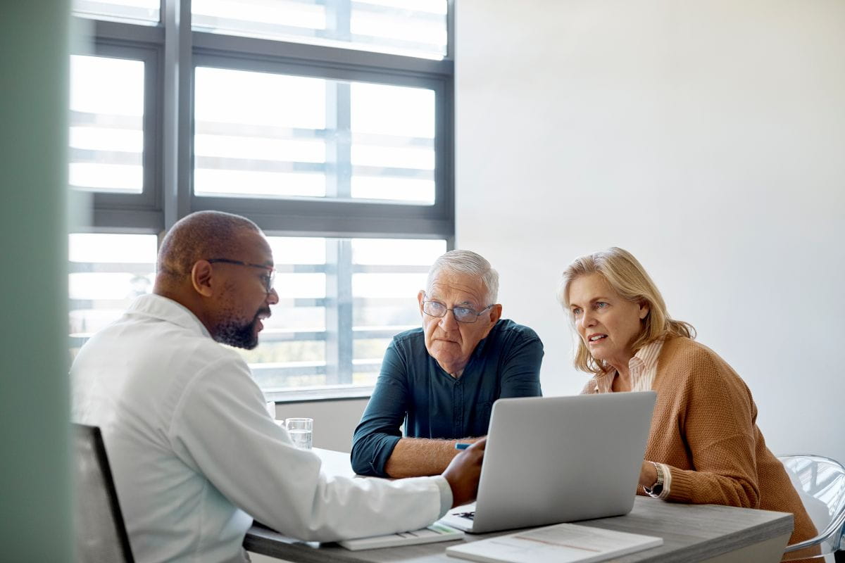 Husband and wife discussing non-invasive surgery options with a doctor at Alexian Brothers Gamma Knife® Center in Elk Grove Village, Illinois.