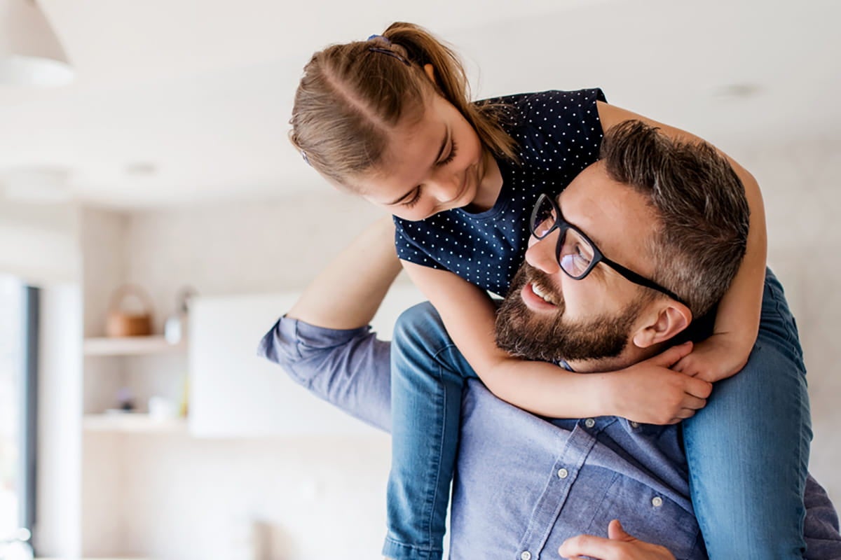 Dad carrying his daughter.