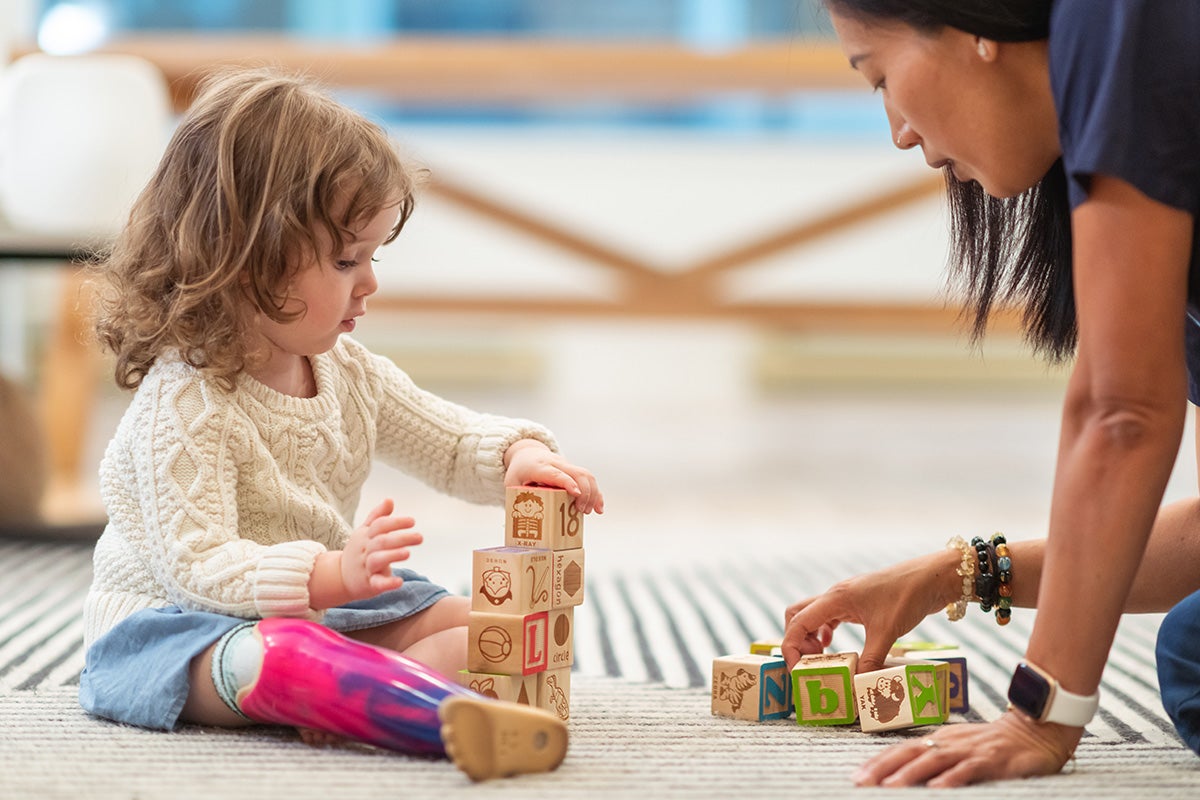 Child playing with a certified child life specialist at Peyton Manning Children’s Hospital in Indianapolis.