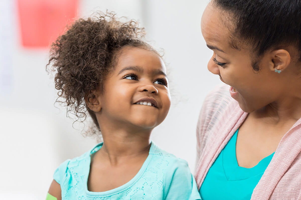 Little girl with mom at doctors office.