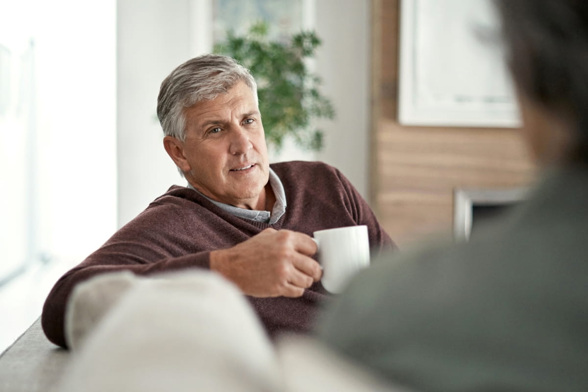 Man having coffee; urologists at Ascension Saint Thomas deliver advanced care for prostate and male genital cancer.