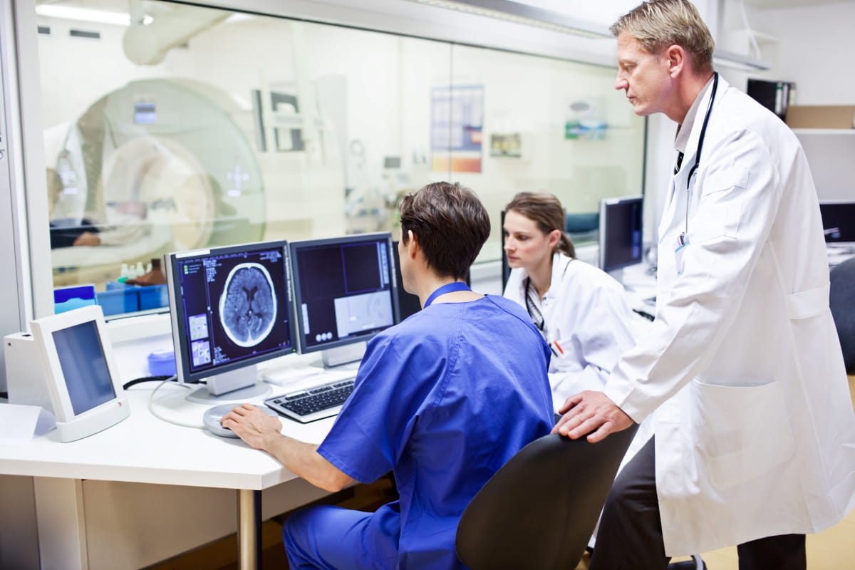 providers looking at MRI image on computer