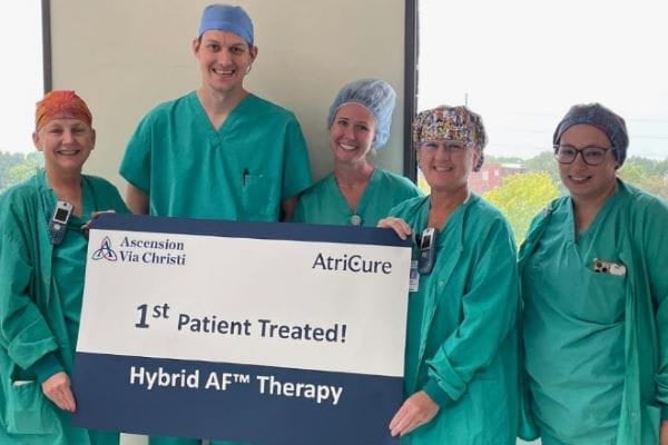 Ascension Via Christi providers hold banner showing 1st patient treated for new AFib treatment