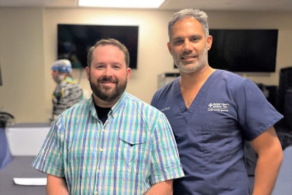 Cardiac nurse, John B., standing next to interventional cardiologist, Rohit Amin, MD.