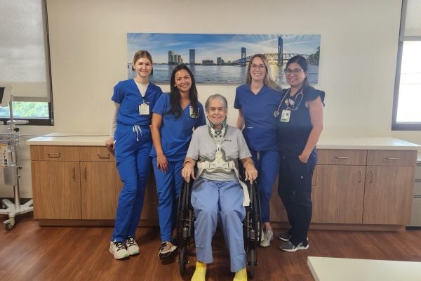 Mr. Santorelli sits with his rehabilitation care team