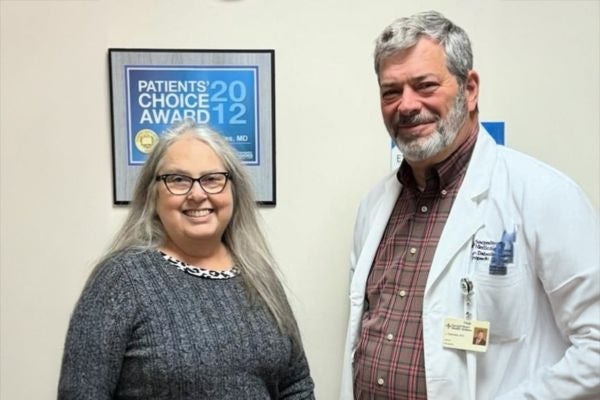 Dr. Eugene Dabezies, an orthopedic surgeon with Ascension Sacred Heart Orthopedics poses with Laura, one of his patients