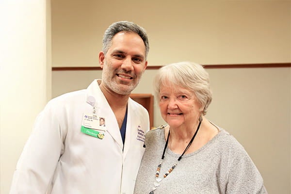 Dr. Rohit Amin, an interventional cardiologist at Ascension Sacred heart, poses for a picture with Glenda, a heart surgery patient.