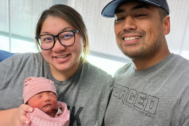 Manhattan area couple Kirstie Anne Flores-Tua'au and Codey Tua'au holds their baby girl Arabella Tua'au