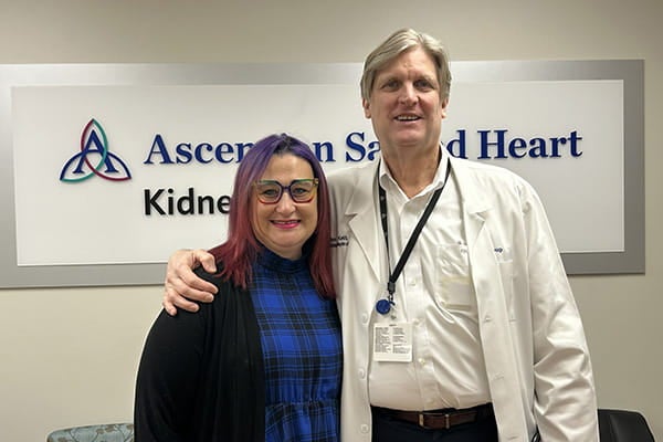 Christine stands with Dr. Douglas Keith, who performed her kidney transplant surgery.