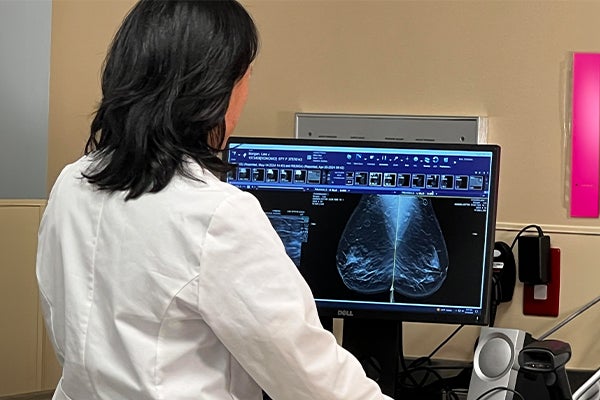 Dr. Christina J. Kim, breast surgical oncologist at Ascension St. Vincent Fishers, reviews a patient’s mammogram images on a computer monitor during a breast cancer screening consultation.