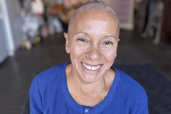 Ovarian cancer survivor Dolores Campbell smiling warmly at the camera.