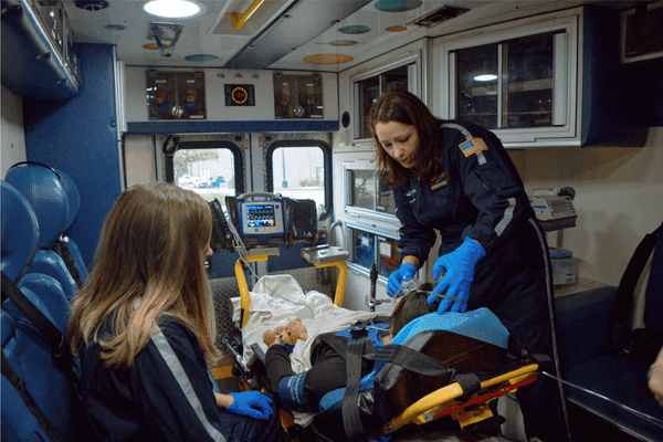 Dell Children's Transport Team cares for a patient inside a critical care transport ambulance.