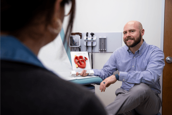 Dr. Joshua Davis explains AFib heart rhythm tracing to a patient.
