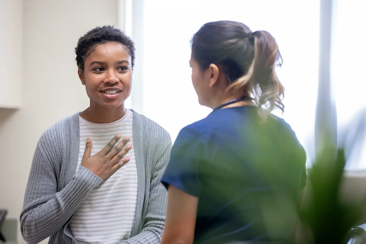 Nurse explaining good news to female patient.