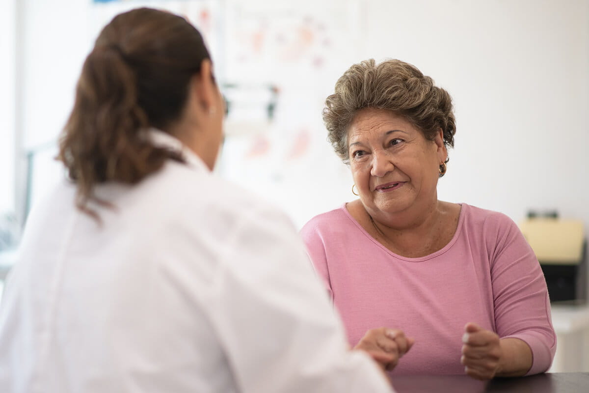 Woman talking with a cardiologist at an Ascension site of care.